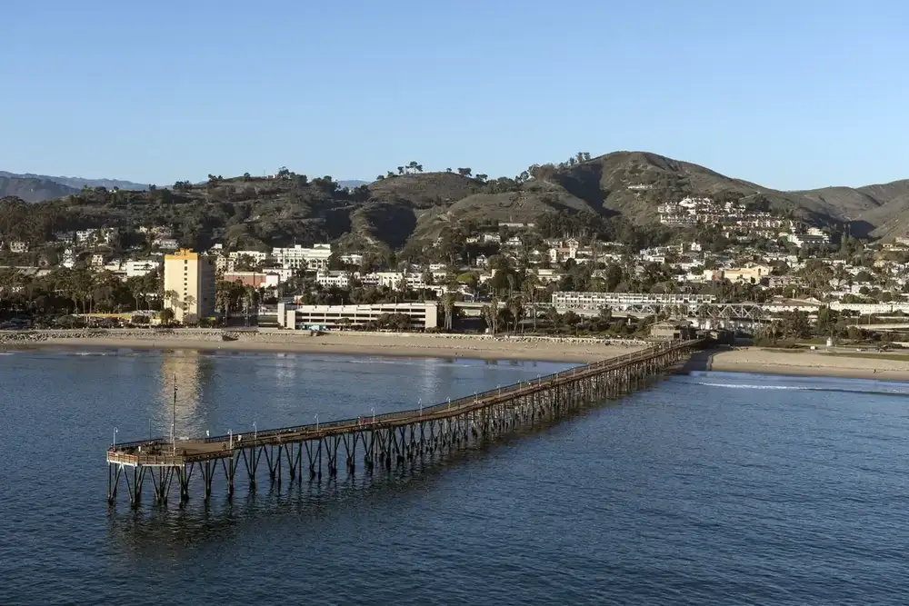 Ventura Pier and the downtown shoreline seen from the air, with the hills behind